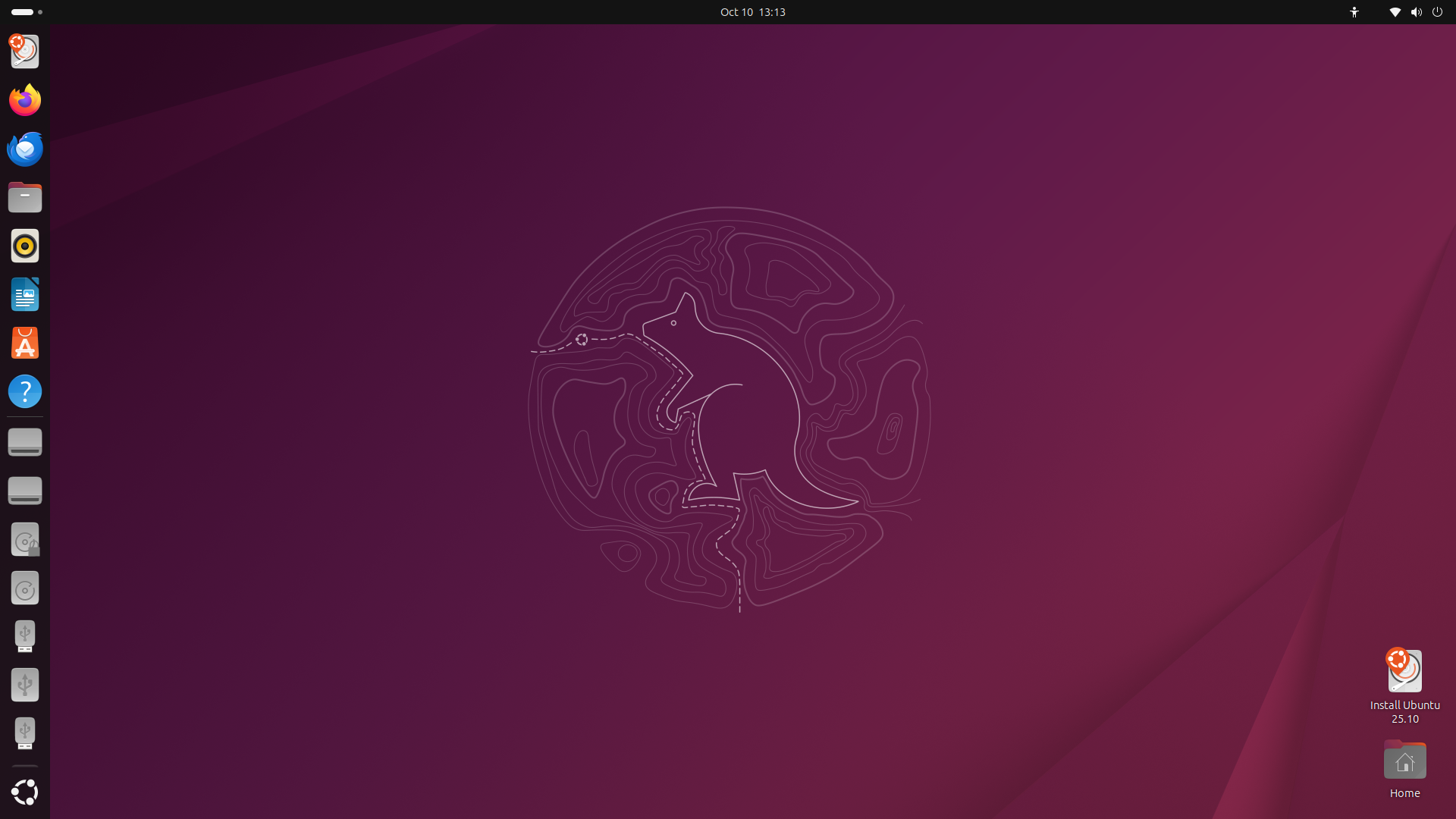 Ambiente de trabalho do Ubuntu com fundo roxo e o contorno de uma raia estilizada, barra lateral de aplicações à esquerda e ícones no canto inferior direito
